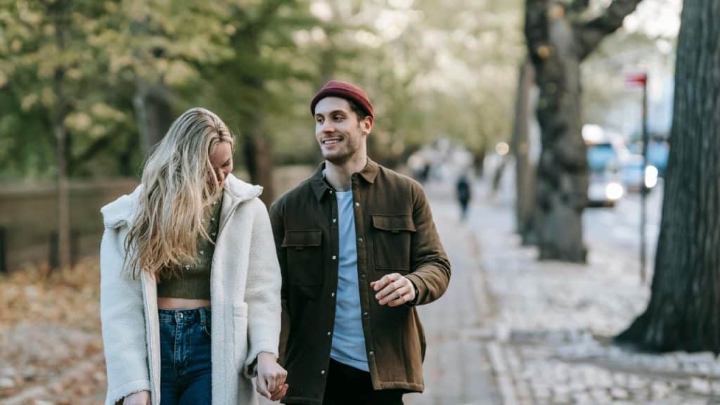 Couple holding hands affectionately while walking