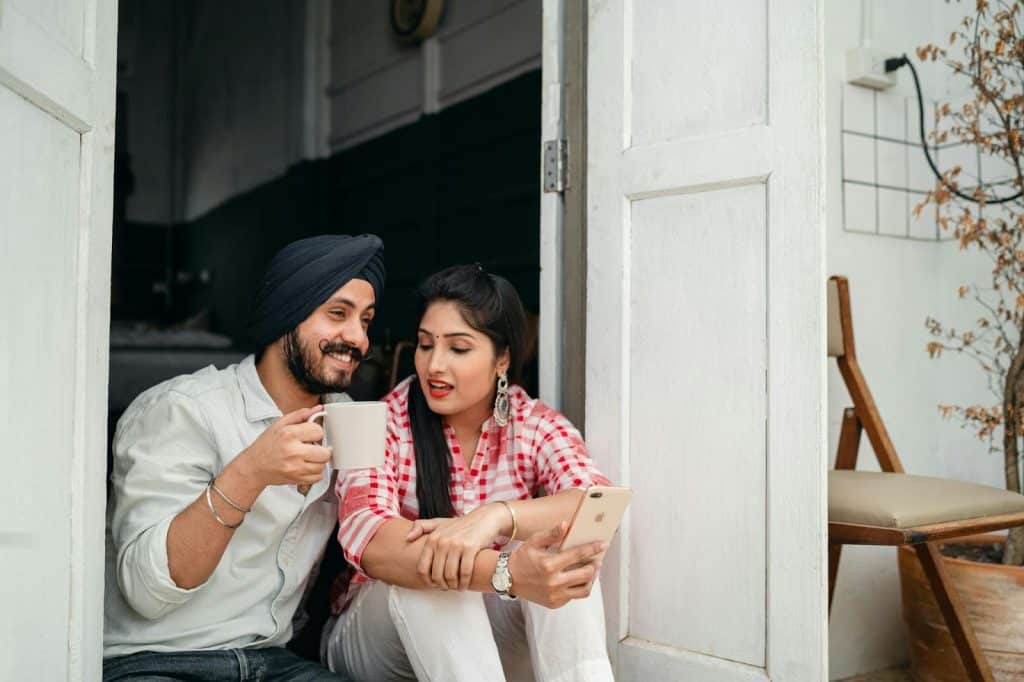 A man and woman sitting at the doorway