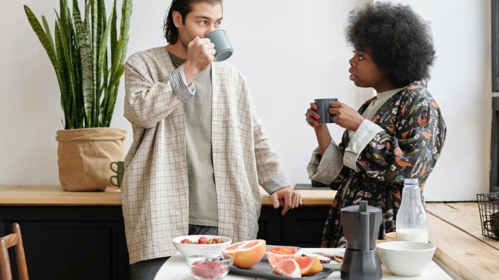 A couple having coffee together in the kitchen.