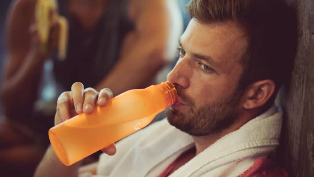 Man choosing water over a beer while out with friends