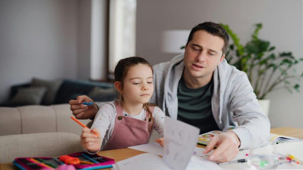 A dad tutoring his daughter