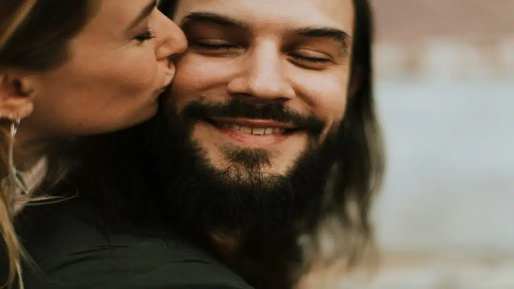 A woman kissing her husband on the cheek