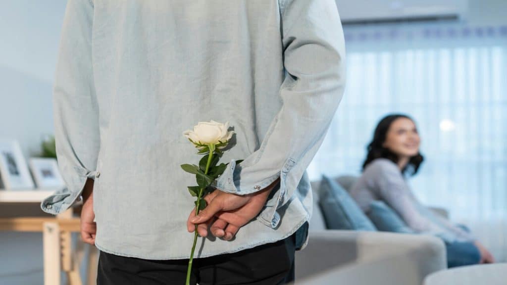 A man surprising his wife with a rose