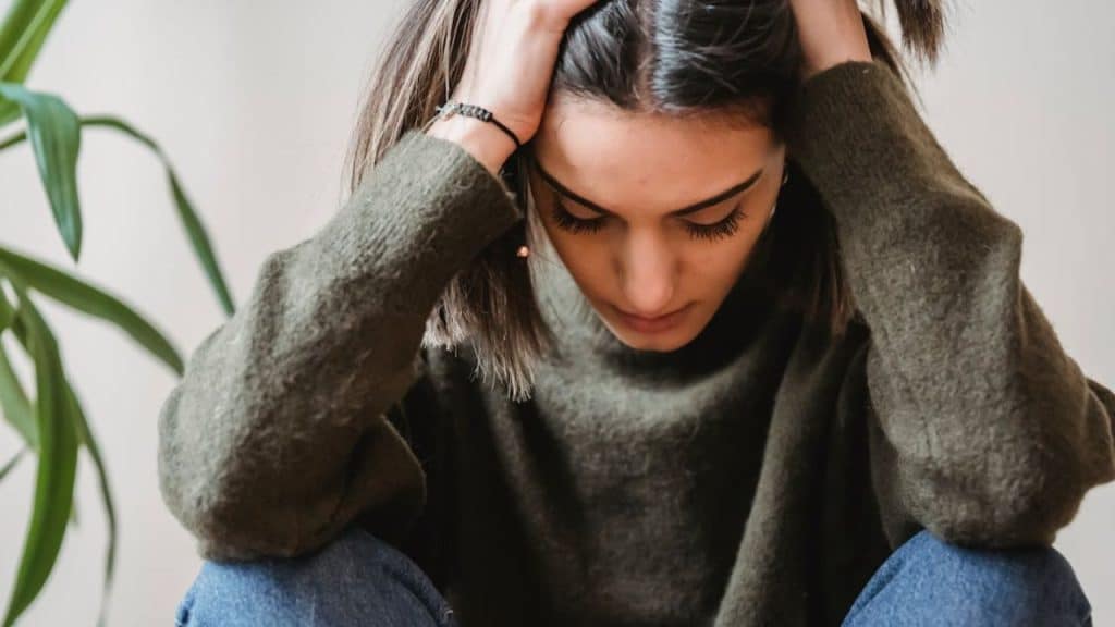 A woman sitting quietly, lost in thought
