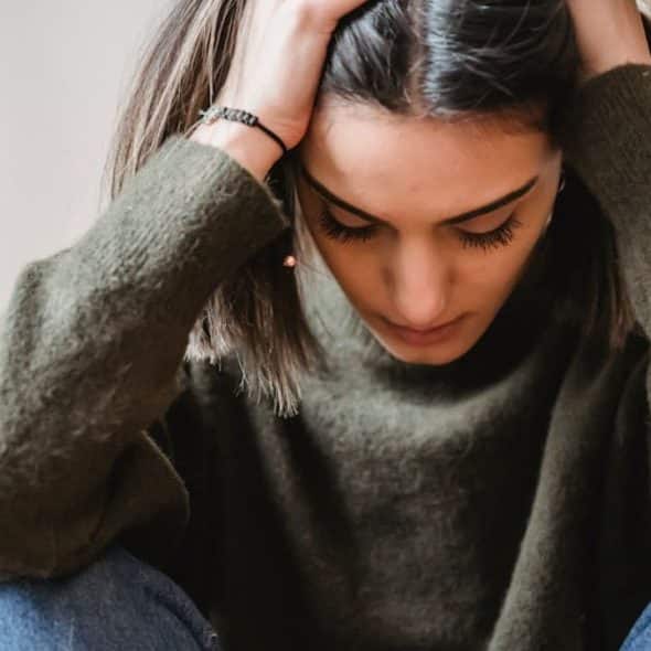 A woman sitting quietly, lost in thought