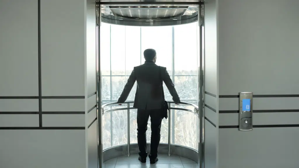 A businessman standing in an elevator