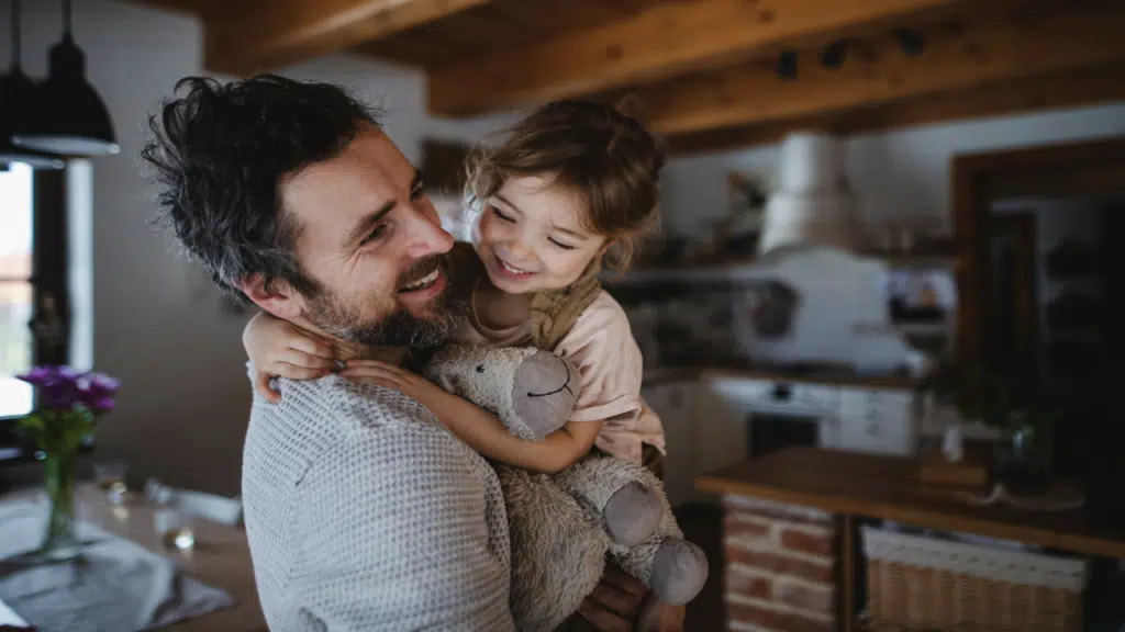 A dad with his daughter at home