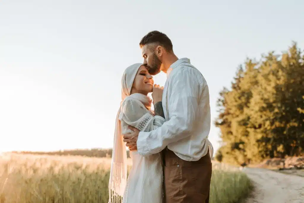 A man kissing woman’s forehead