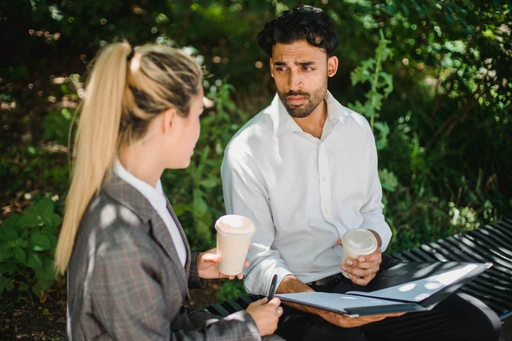 A man bringing coffee for a woman