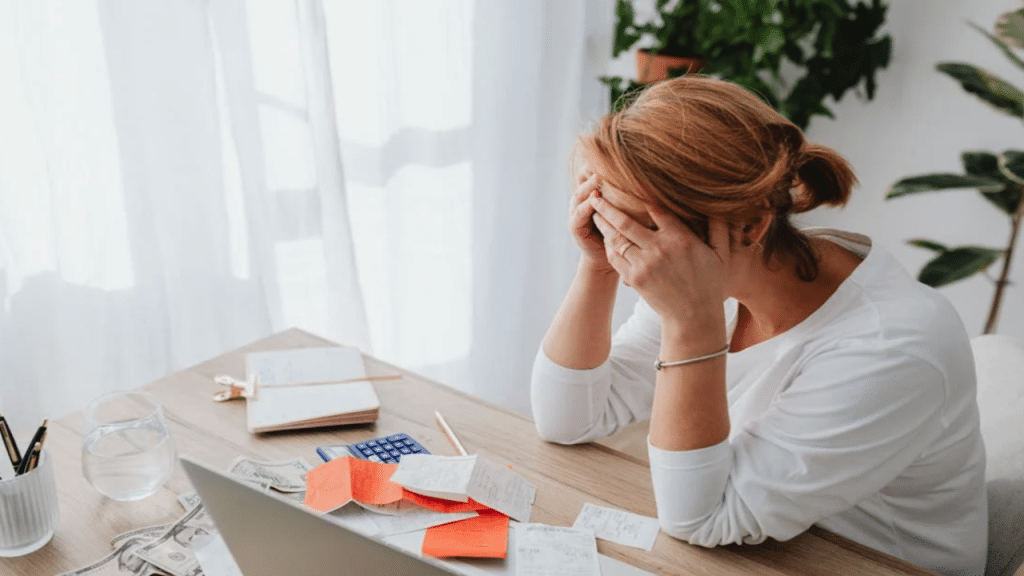 A woman stressed over receipts