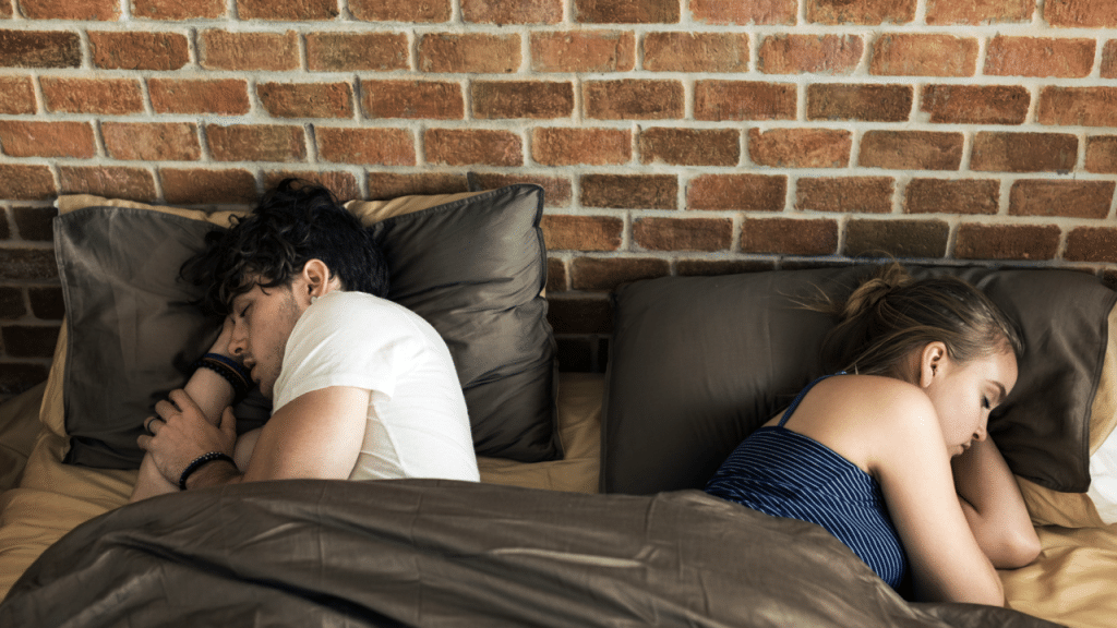A couple sleeping back to back