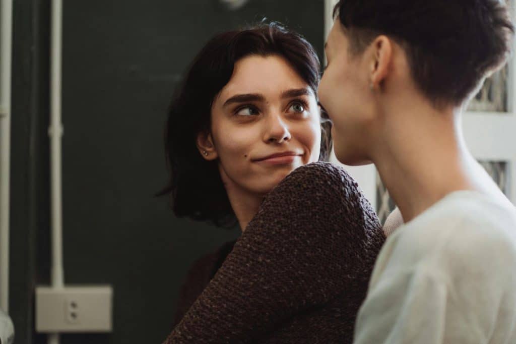 A woman looking at the man