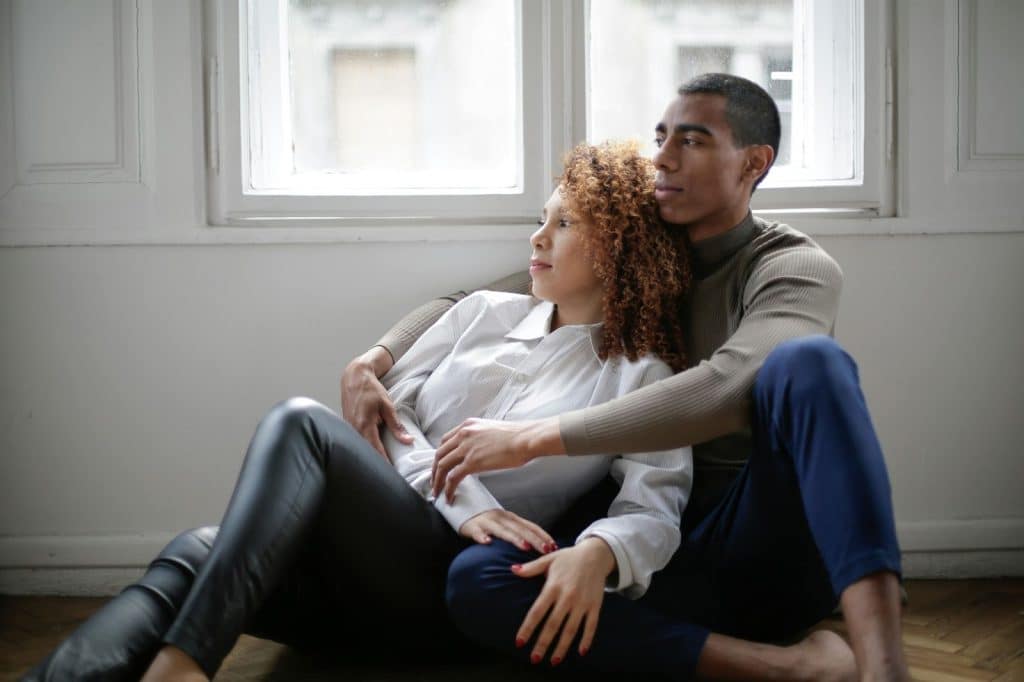 A woman leaning on a man’s chest