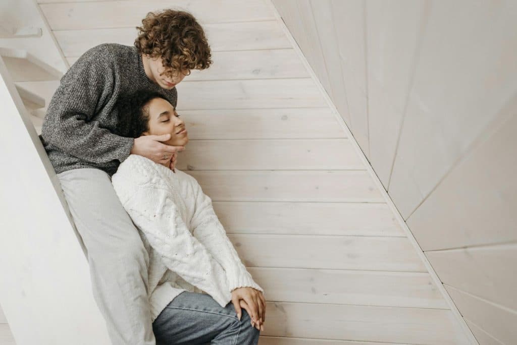 A man holding a woman’s face