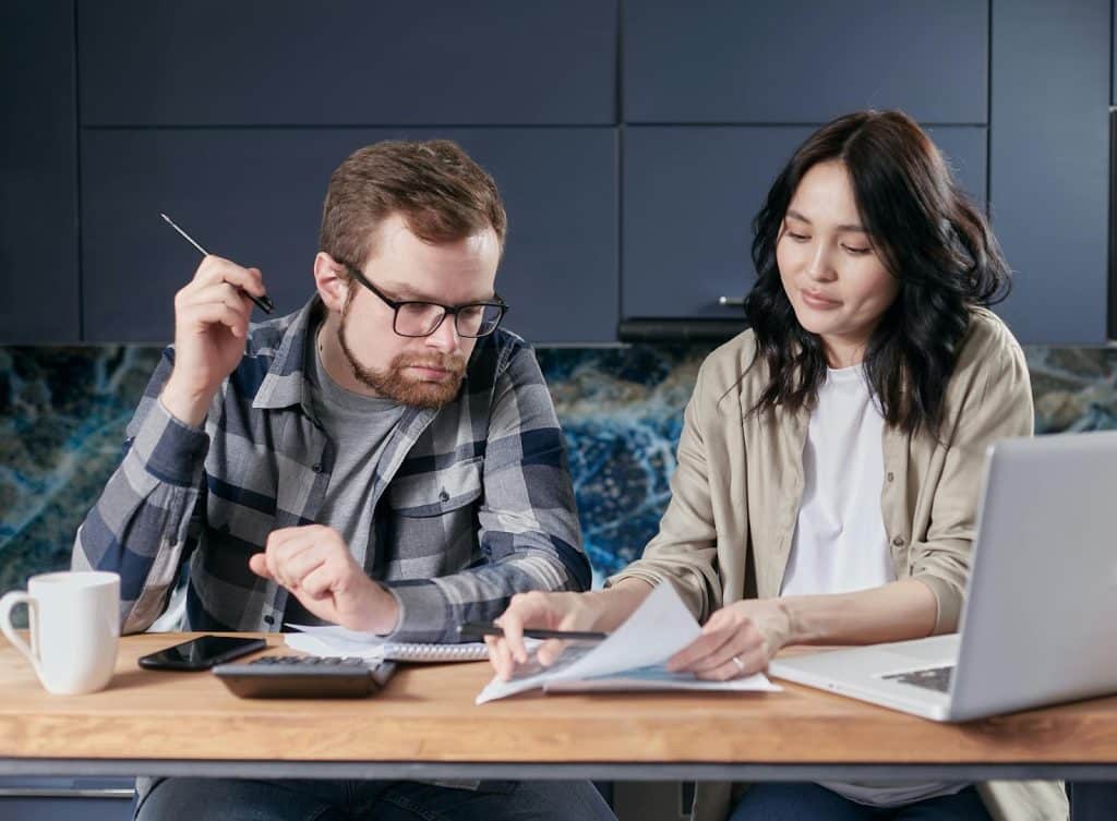 A man and woman computing bills