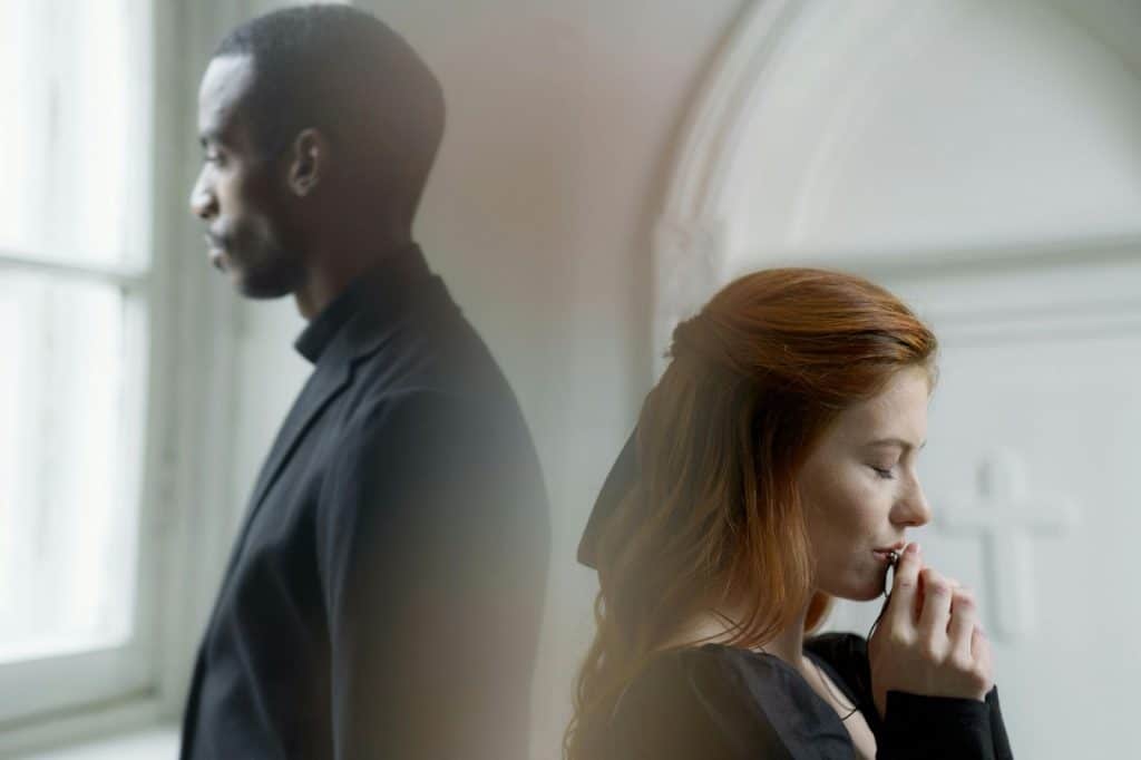 A man and woman back to back with each other