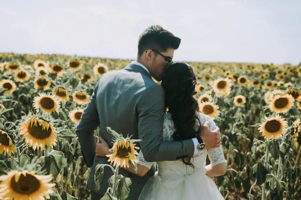 A man kissing a woman’s head