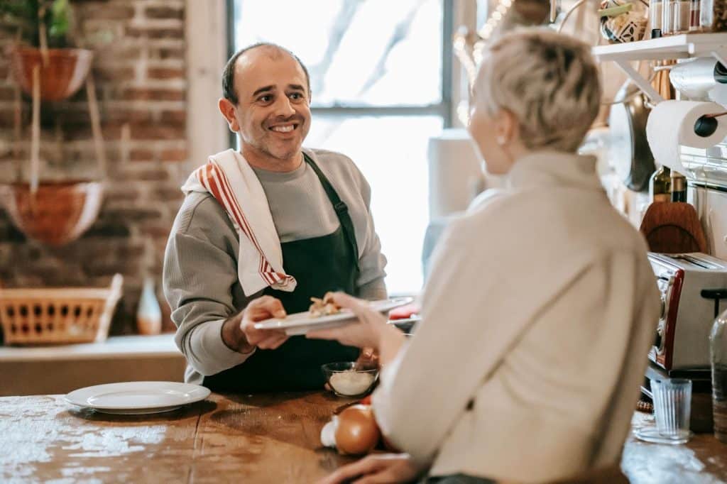 A man cooking for a woman