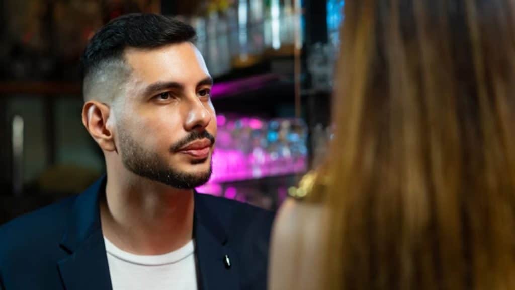 Man frowning at his partner’s outfit before a night out