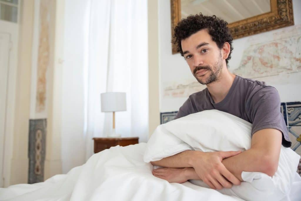 A man sitting at the bed