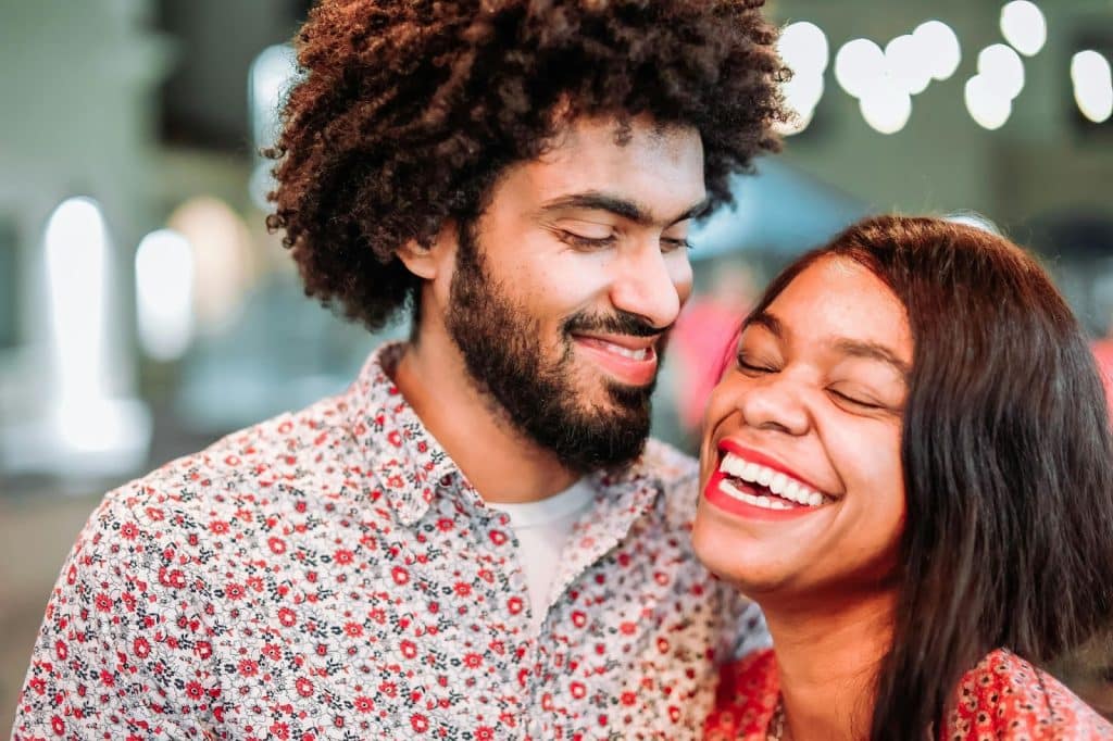 A man making a woman laugh