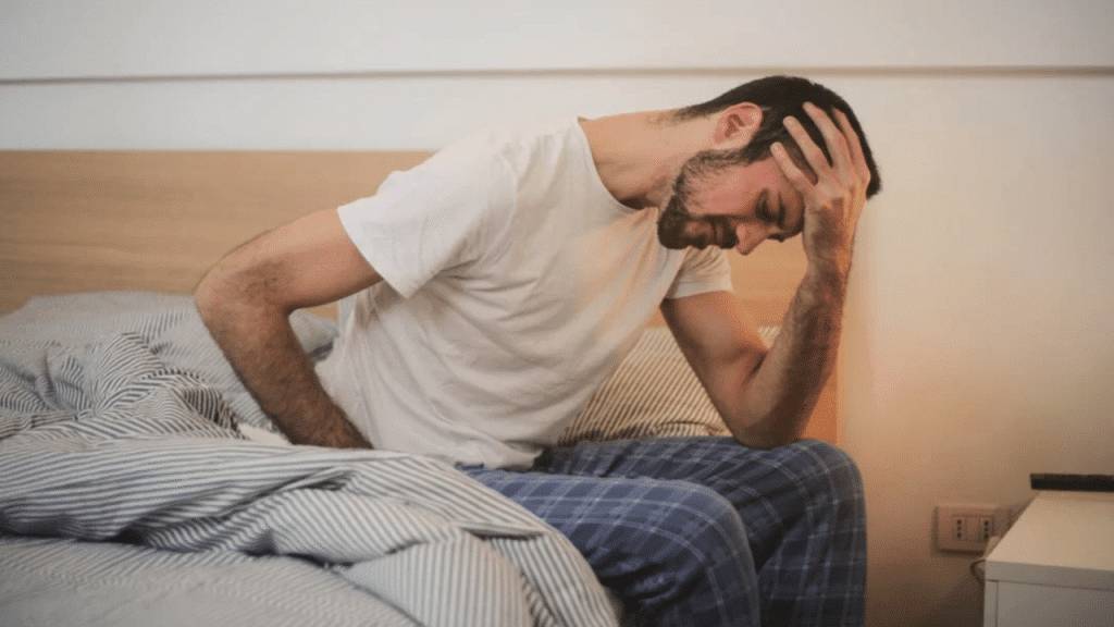 A man looking tired in bed