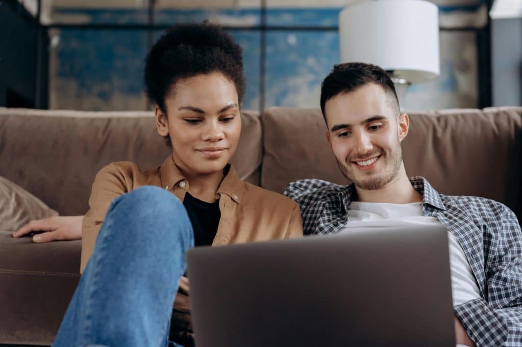 A man and woman sitting at the floor