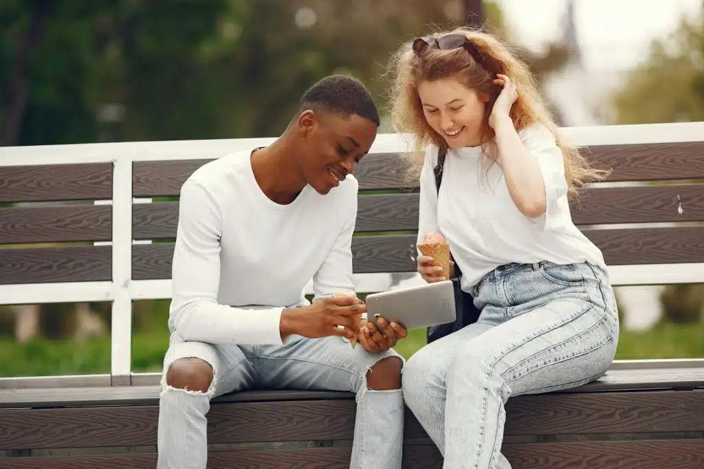 A man and woman sitting at the bench