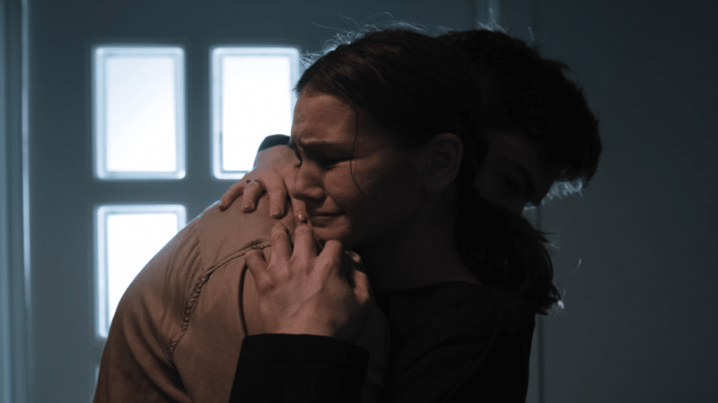 A man comforting his crying wife