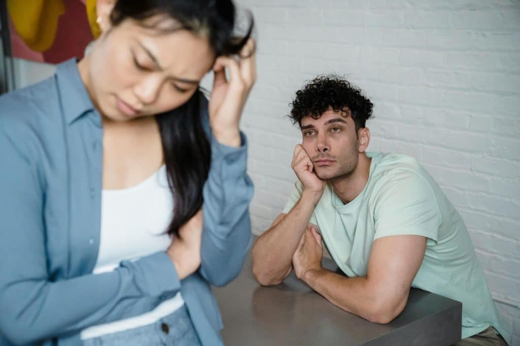 A man thinking while looking at the woman