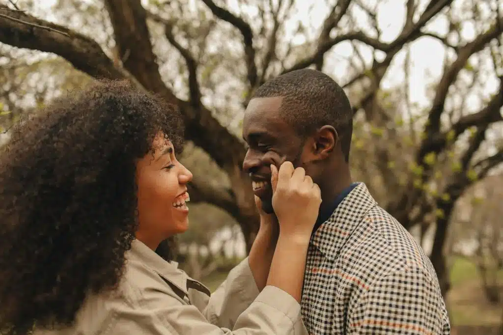 A woman pinching a man’s face