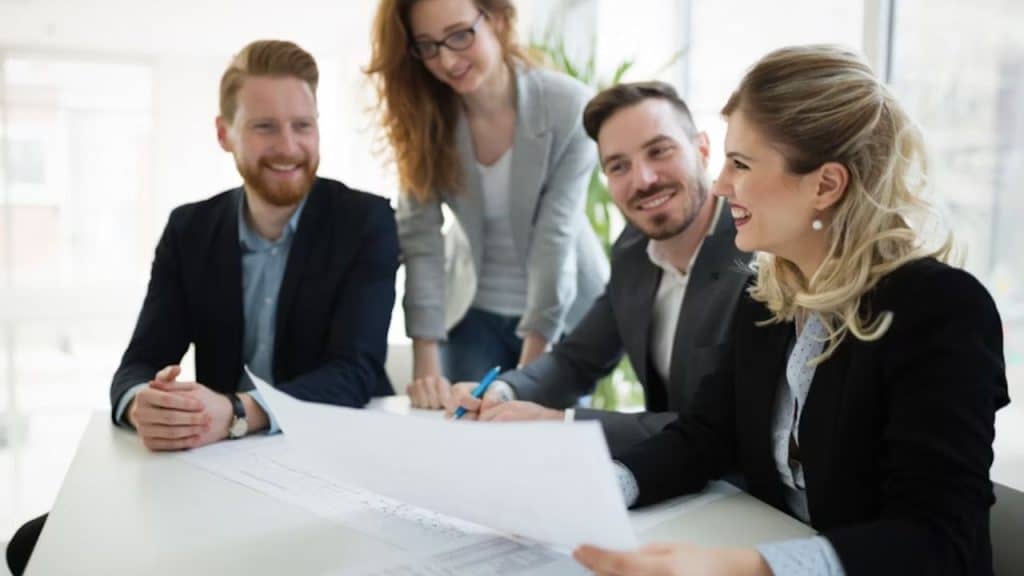Man looking upset as his partner laughs with a coworker
