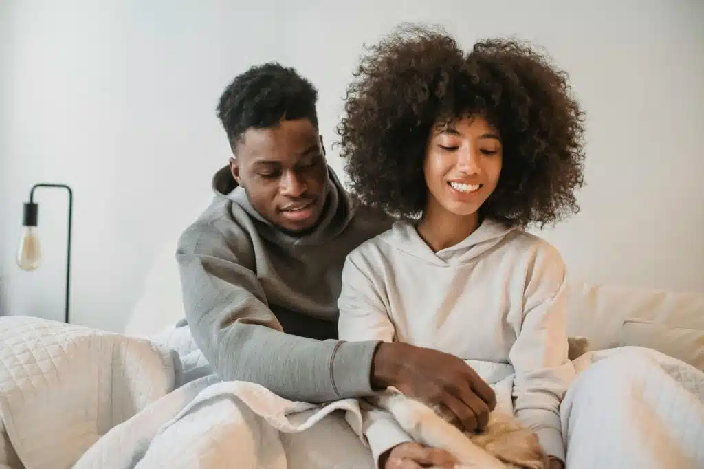 A man and woman at the bed