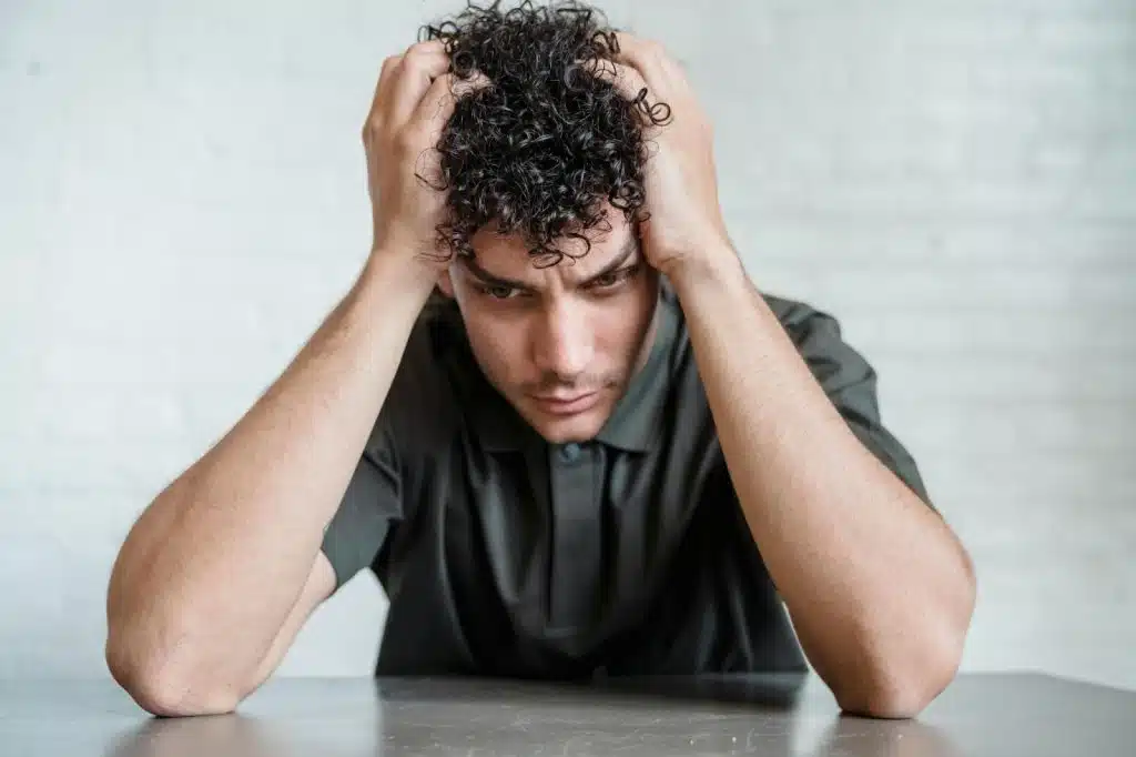 A man holding his head