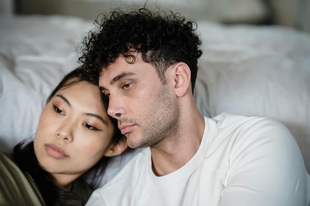 A man and woman leaning at each other