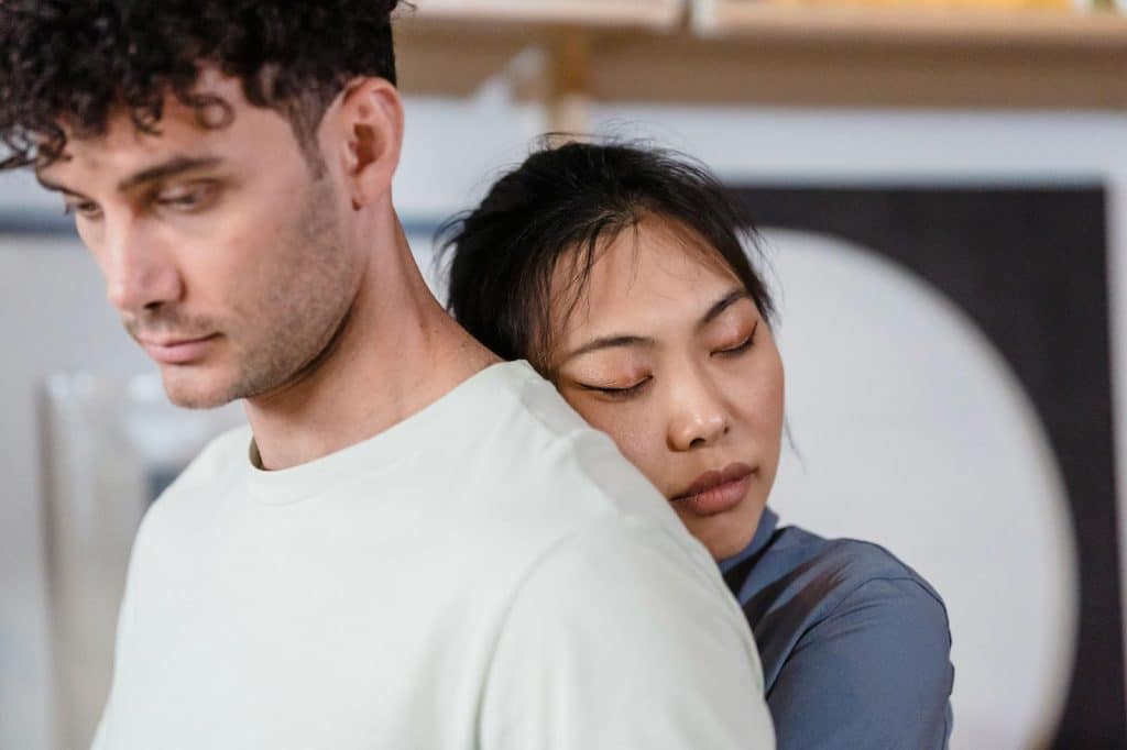 A woman hugging a man