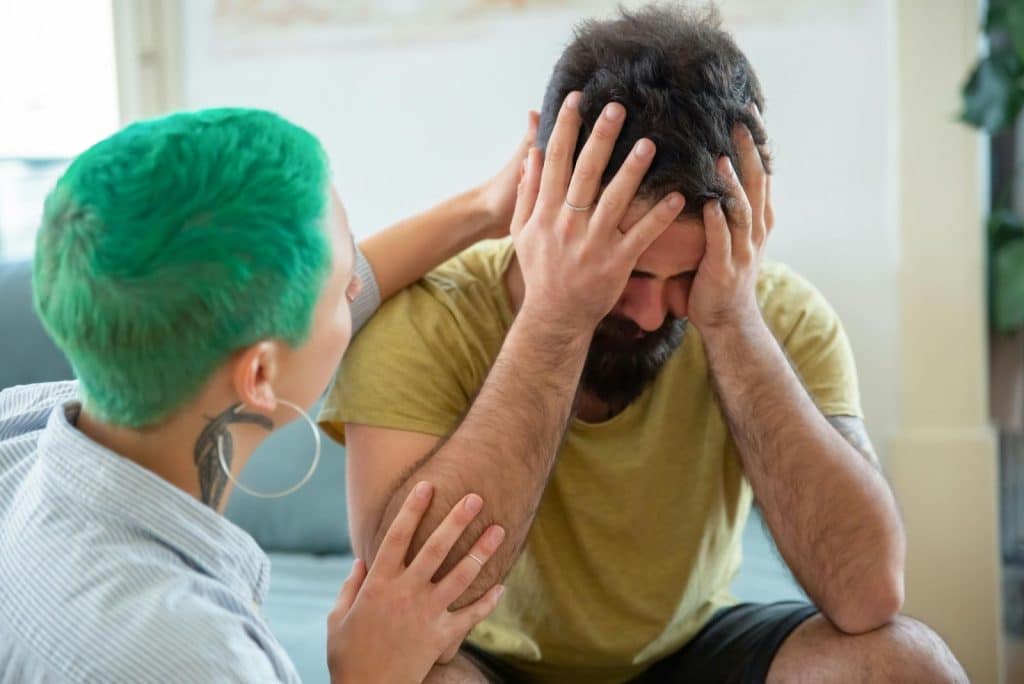 Woman comforting a man