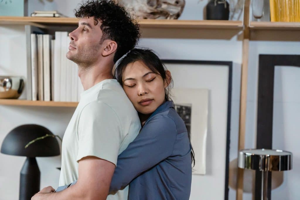 A woman hugging a man from behind