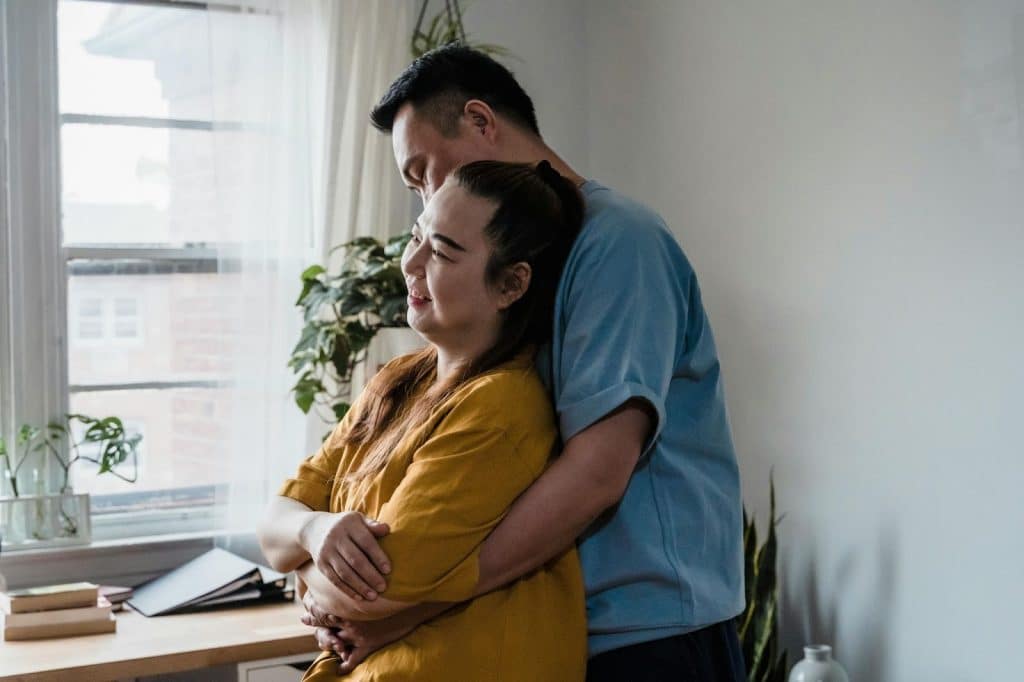 A man hugging a woman