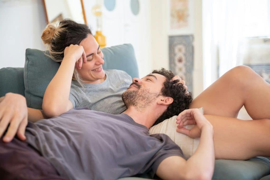 A man laying on a woman’s tummy