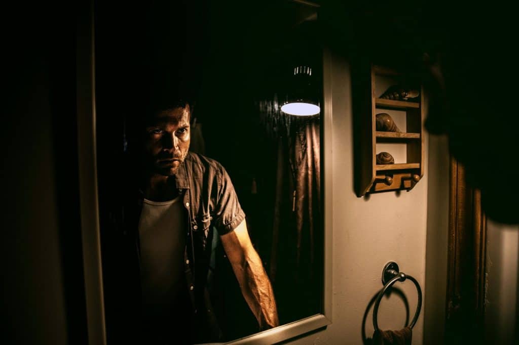 A man looking at the mirror