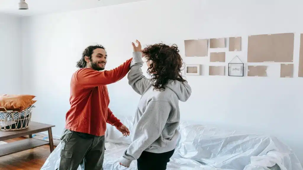 A couple high fiving at home
