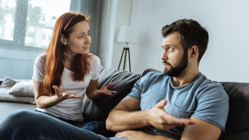 Man lecturing while wife talks defensively