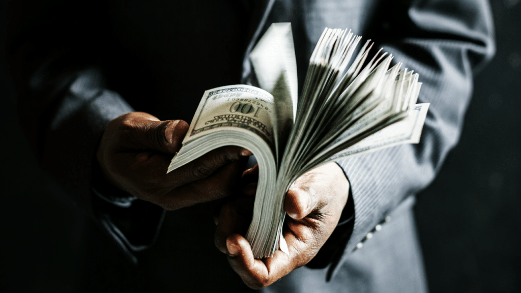 A man holding dollar bills