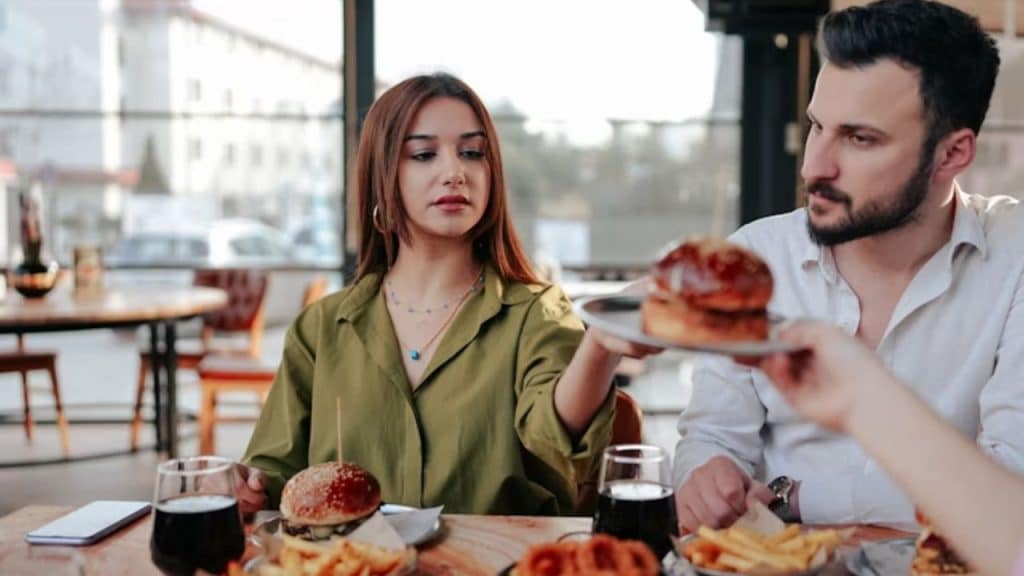 Man frustrated while eating fast food