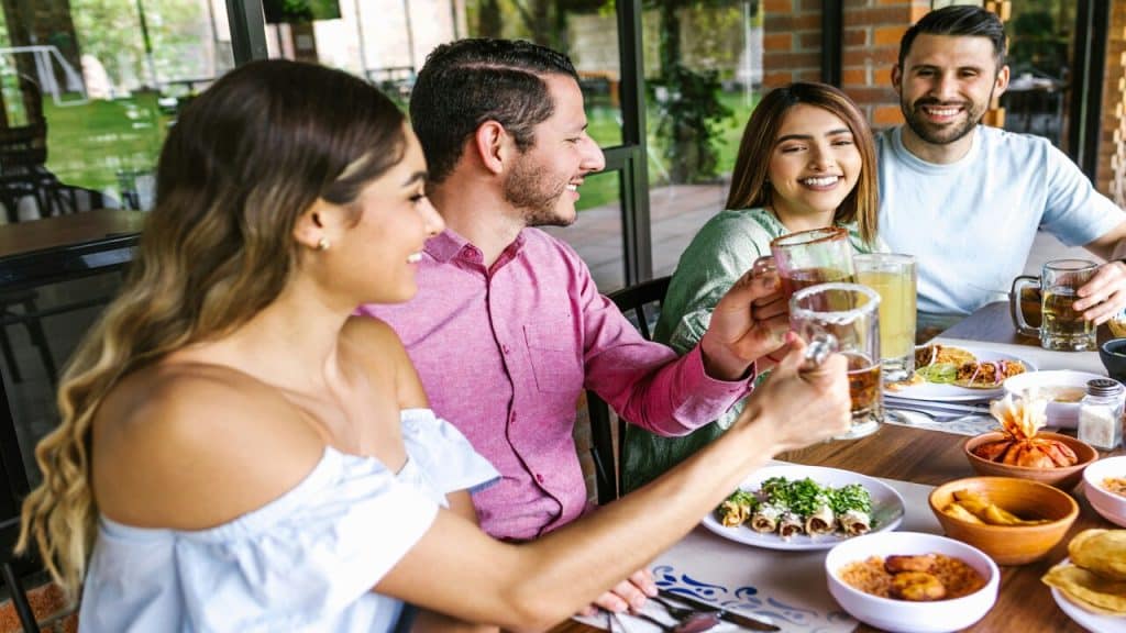 Friends laughing while having a meal together