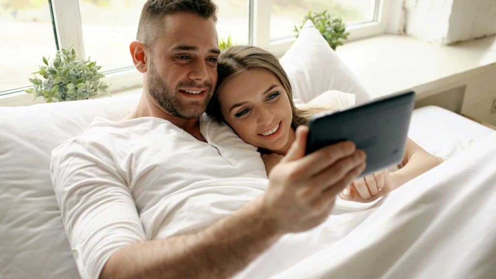 A couple looking at a tablet together