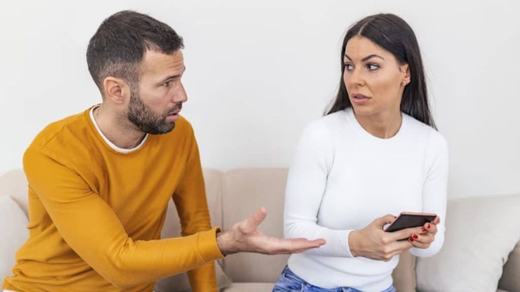 Man making sarcastic remark while wife looks hurt