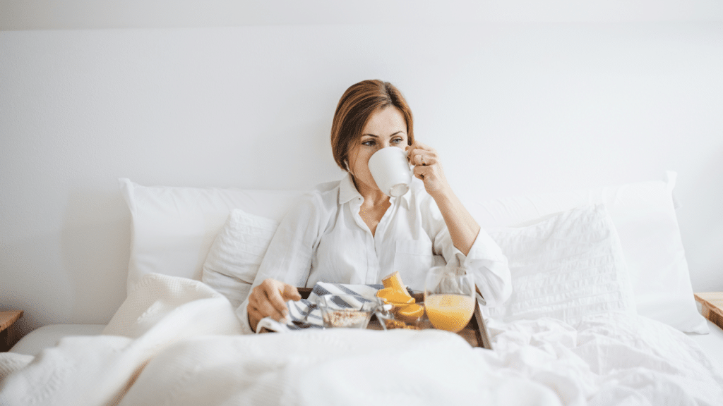 A woman having breakfast in bed by herself