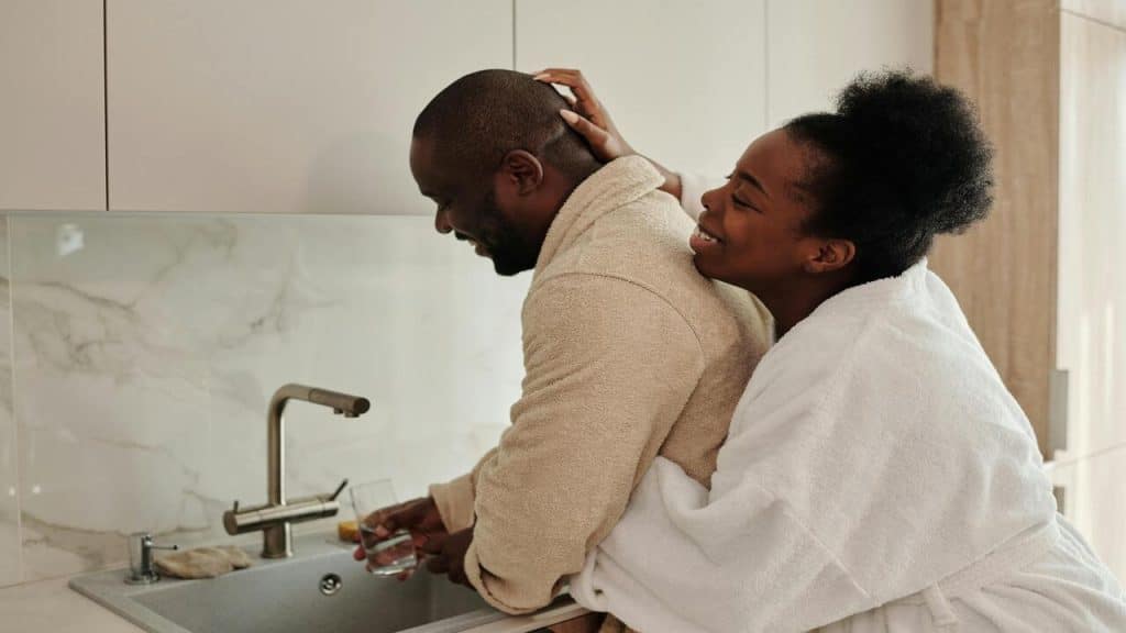 A couple hugging in the kitchen